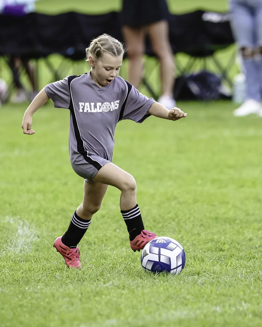 Youth soccer player mid-action with the ball