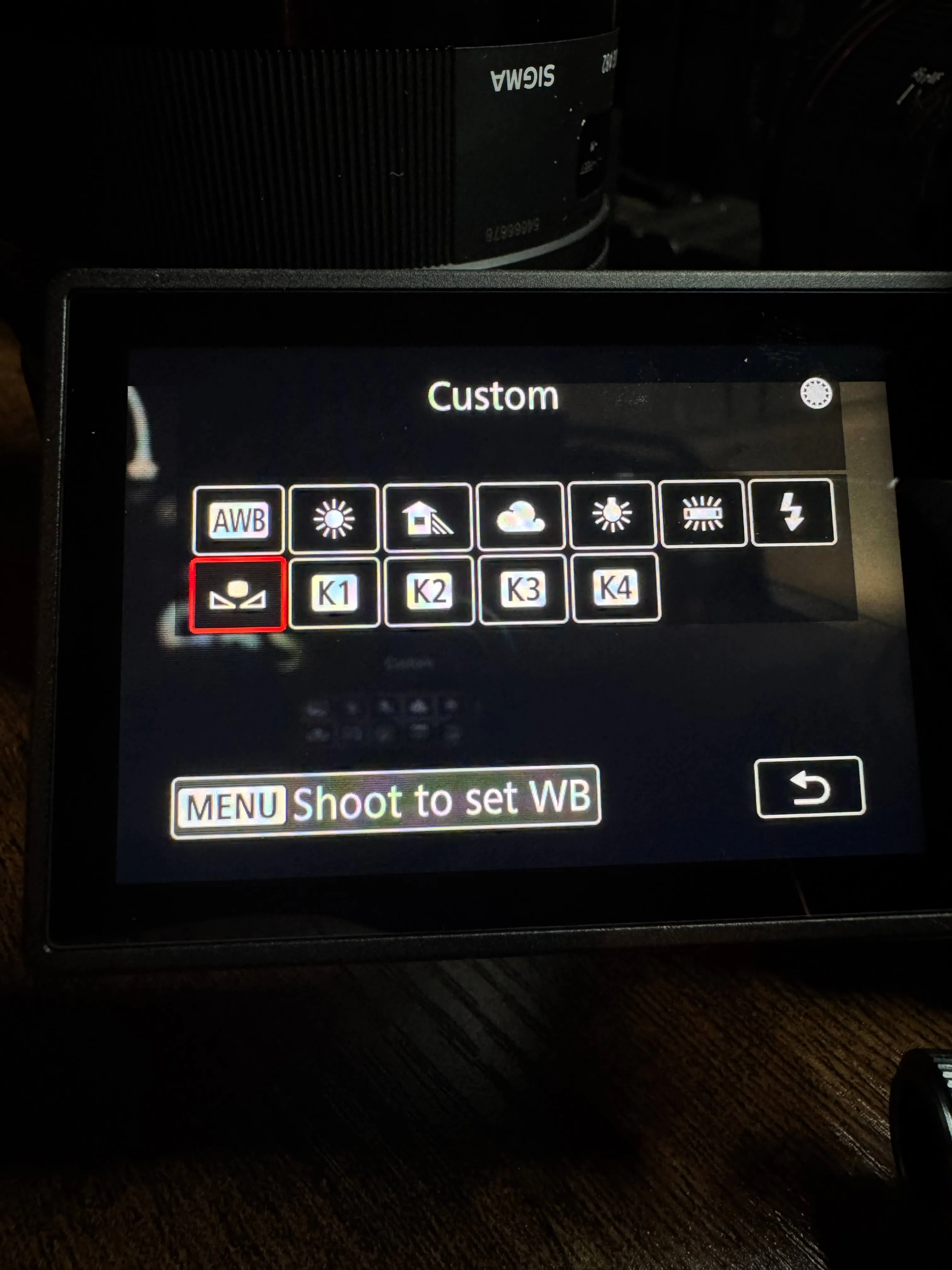 Canon mirrorless camera LCD screen displaying the white balance menu with AWB selected and preset icons visible including Kelvin.